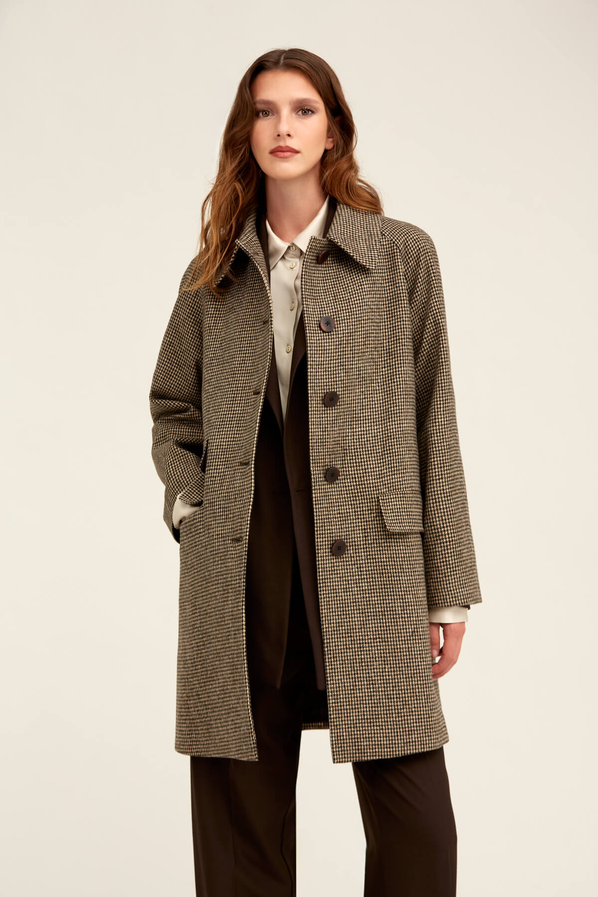 A stylish brown and beige houndstooth wool coat with a classic double-breasted design.