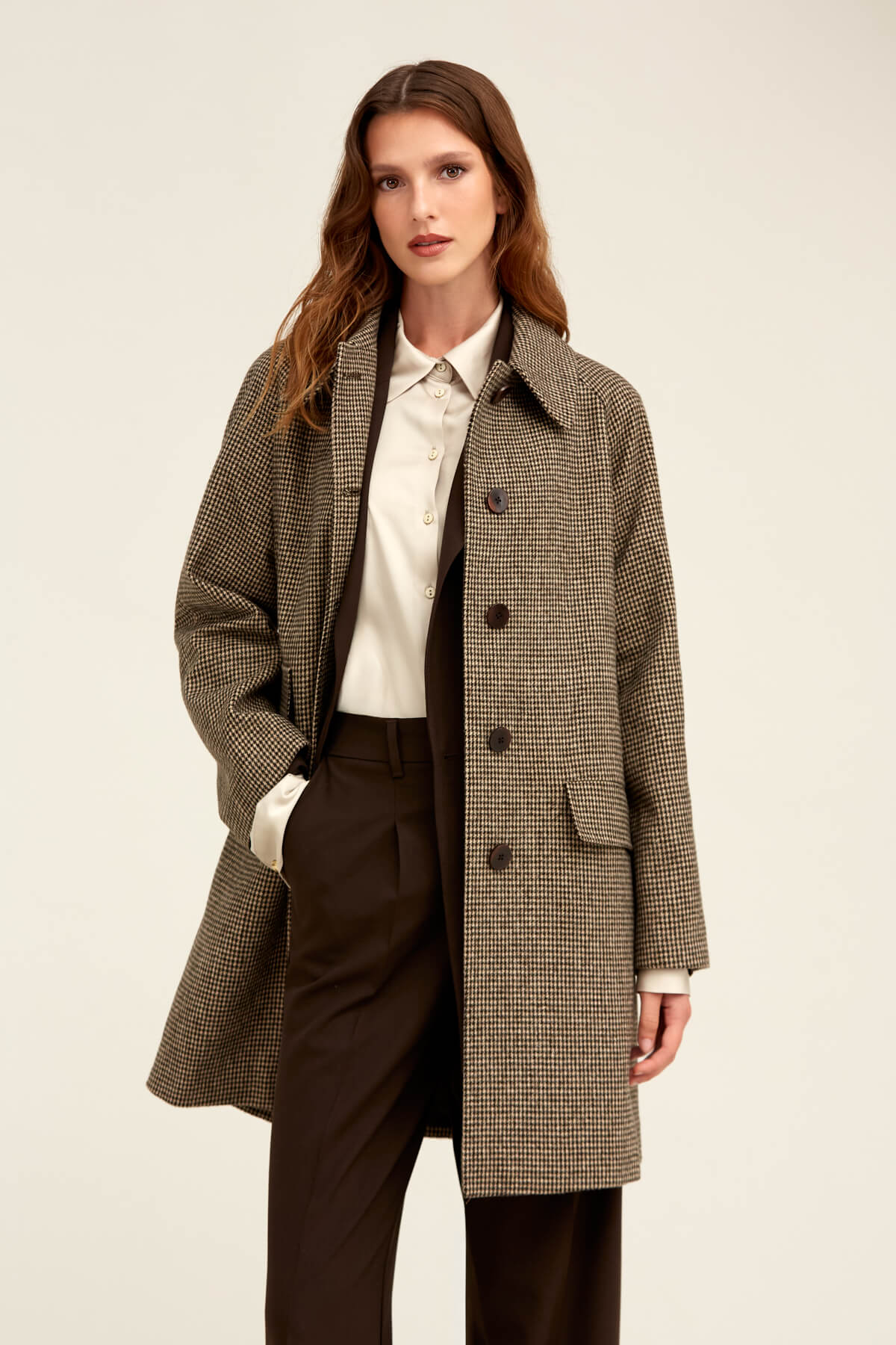 A stylish brown and beige houndstooth wool coat with a classic double-breasted design.