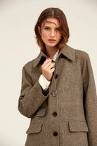 Brown and beige houndstooth wool coat with dark brown buttons.