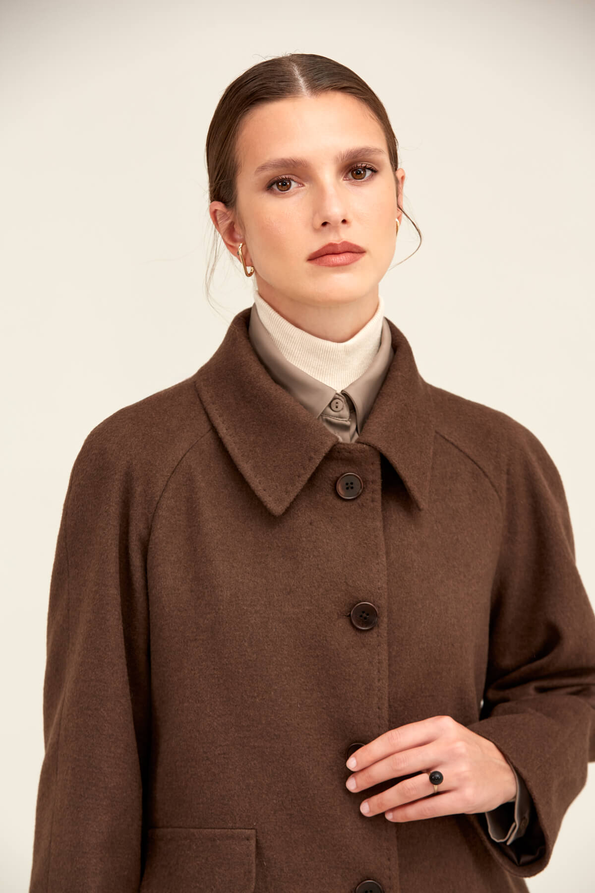 Brown wool coat with a classic collar and dark buttons.