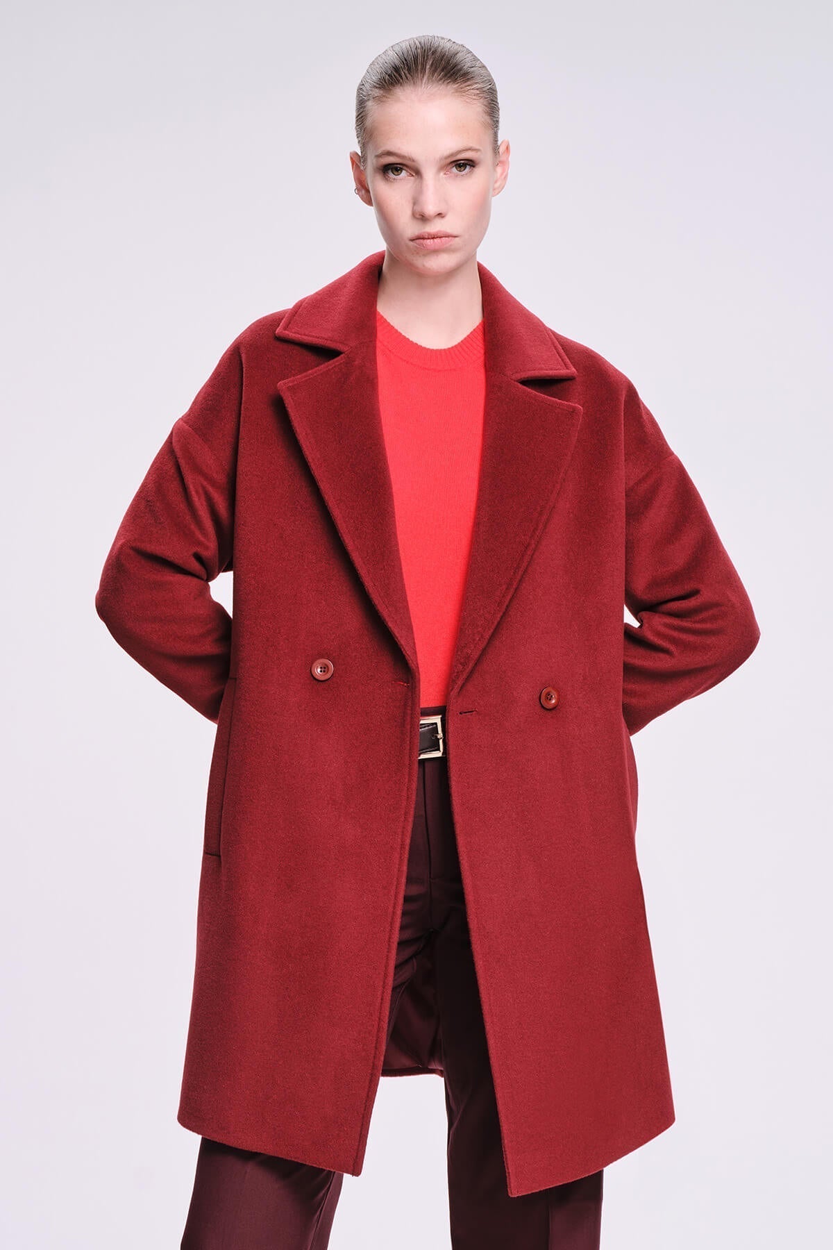 A rich crimson wool coat with a classic double-breasted design and matching buttons.