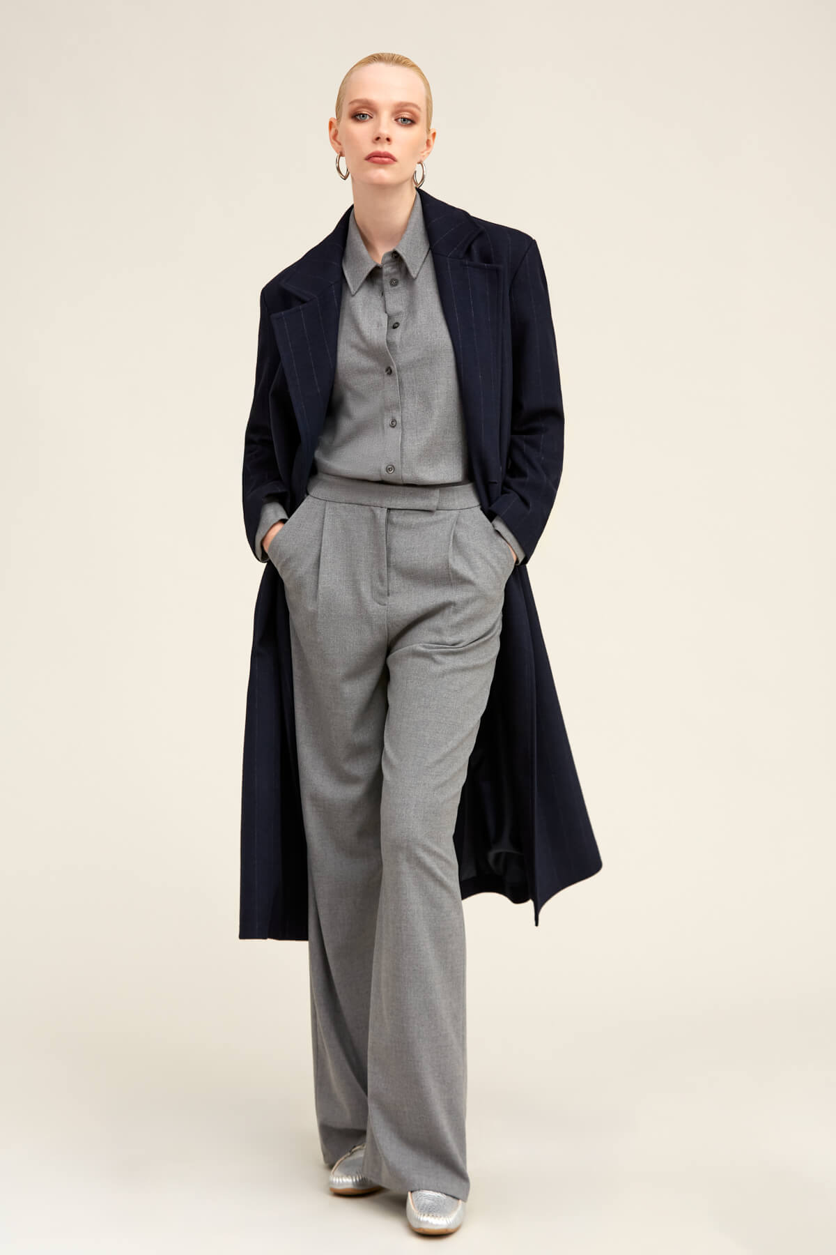 Navy blue wool overcoat with notched lapels and a structured silhouette