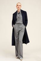Navy blue wool overcoat with notched lapels and a structured silhouette