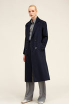 Navy blue double-breasted wool coat with silver buttons and subtle vertical pinstripes