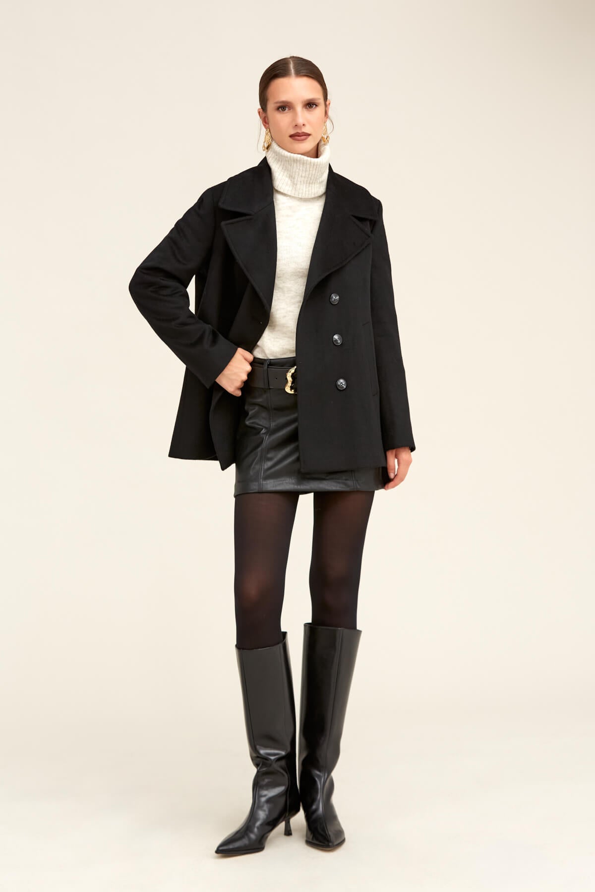 Black double-breasted coat with notched lapels and dark buttons.