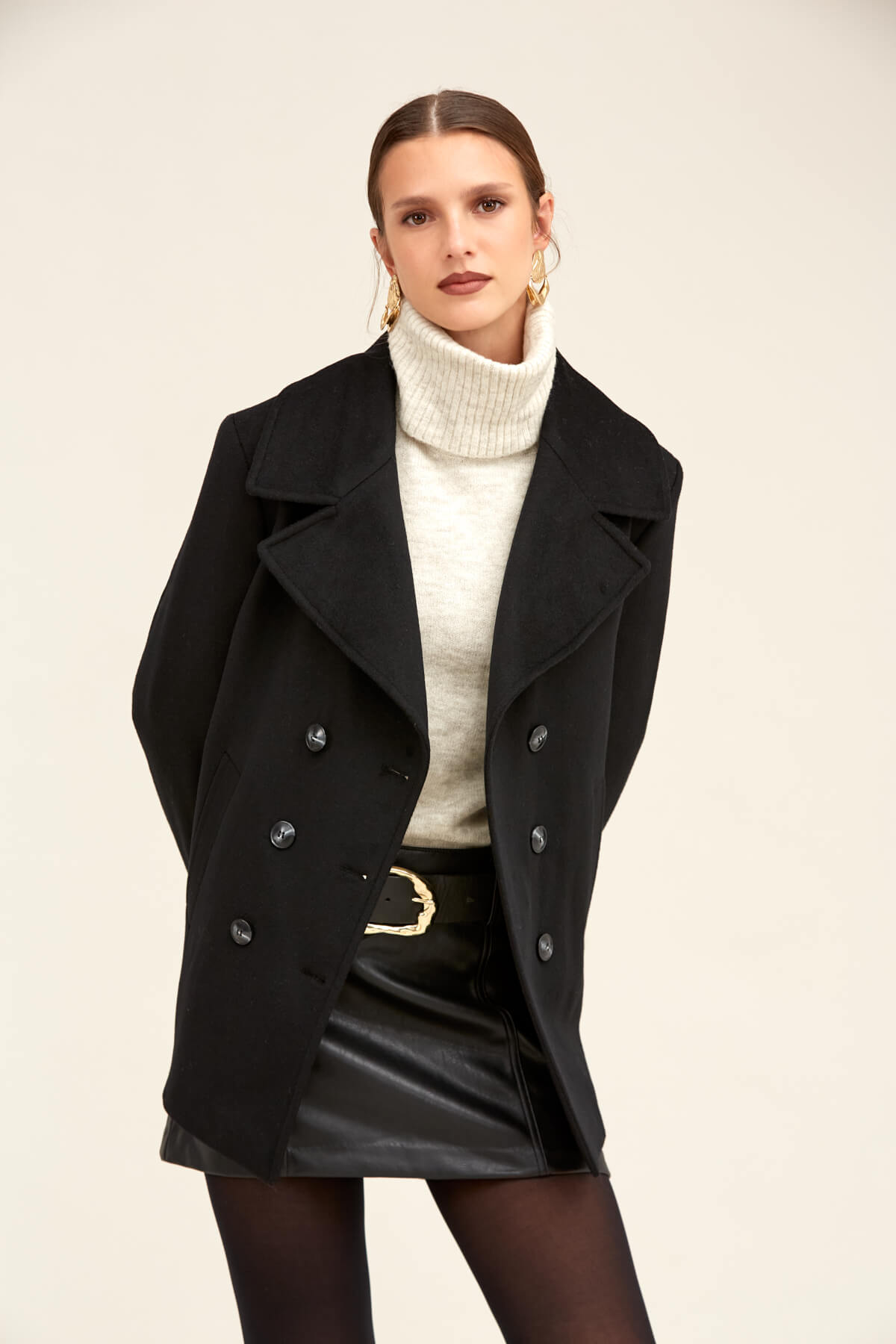 Black double-breasted wool coat with silver-toned buttons.