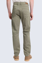 Olive green dynamic fit cotton gabardine chino pants with five pockets and brown leather brand patch for smart casual wear