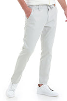 Light gray chino pants with a drawstring waistband and tapered legs.