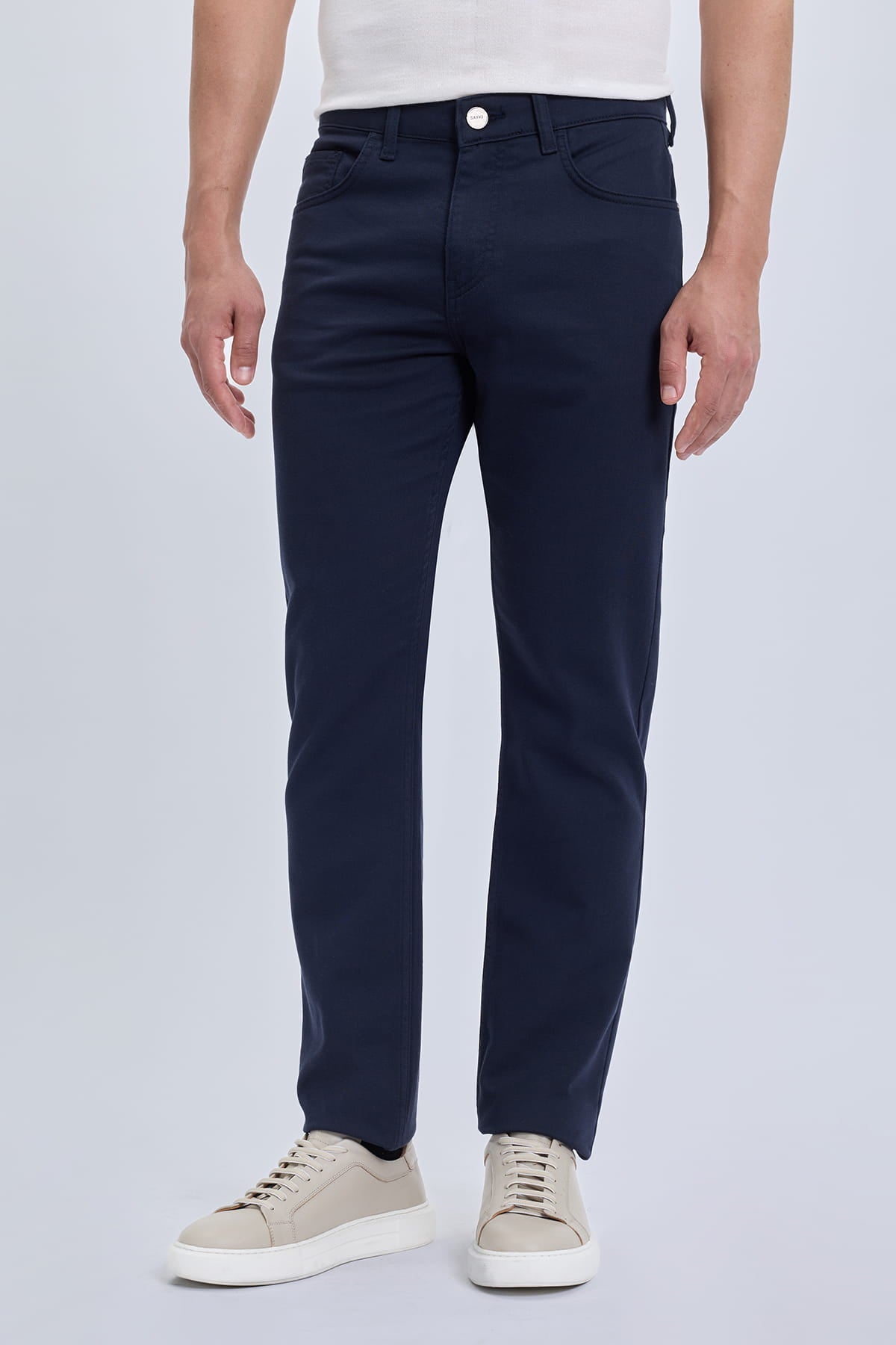 Dynamic fit navy cotton gabardine slim-fit casual pants in smart casual style with five-pocket design and white button