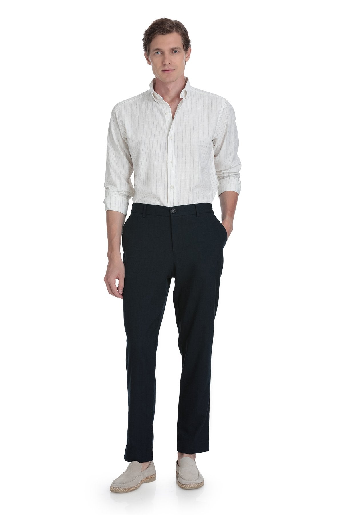 A man wearing a crisp white striped shirt with dynamic fit navy linen blend jogger pants for smart casual style