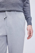 Light gray textured trousers with a drawstring waistband.