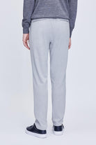 Light gray, slim-fit chinos with a subtle texture and buttoned back pockets.