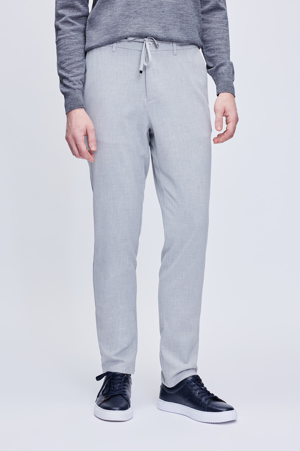 Light gray, slim-fit chino pants with a drawstring waistband.