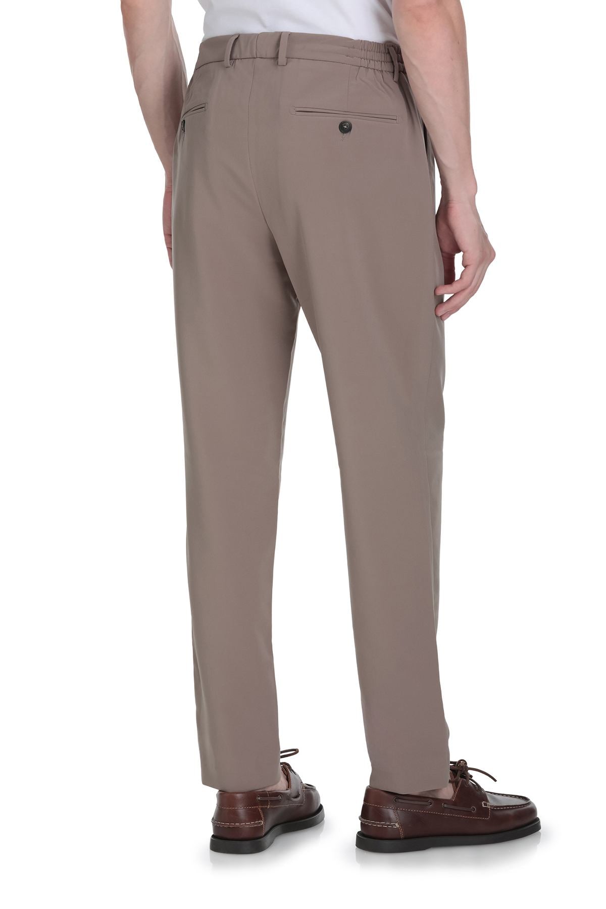 Beige tailored trousers with a belt loop and buttoned back pocket.