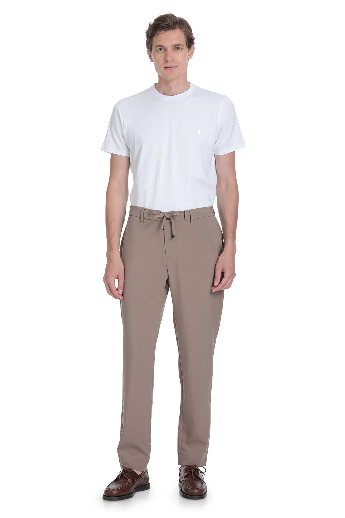Beige tapered trousers with a drawstring waistband and subtle side pockets.
