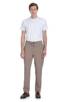 Beige tapered trousers with a drawstring waistband and subtle side pockets.