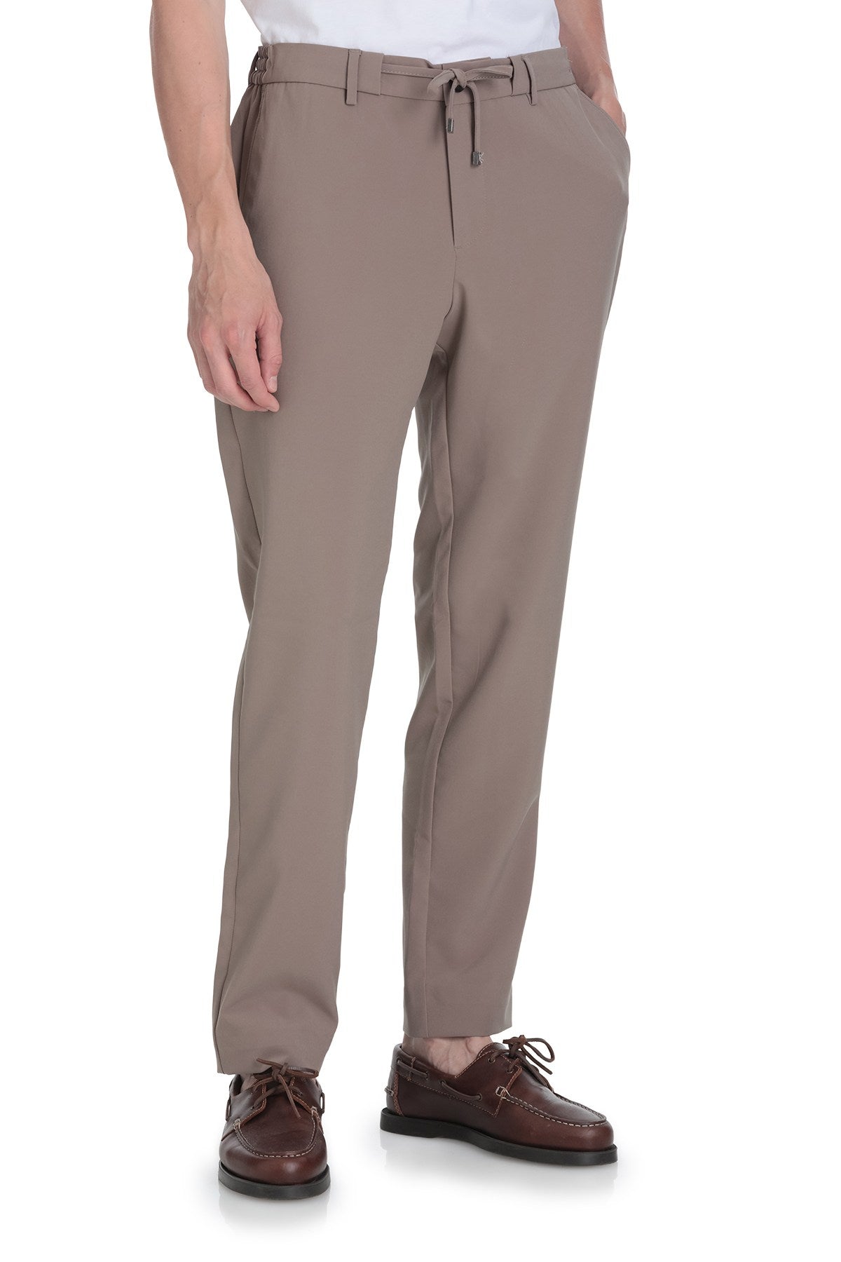 Beige drawstring trousers with a sleek, modern cut and subtle creases.