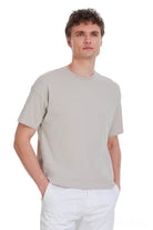 Ecru oversize crew neck t-shirt with short sleeves made of smooth lightweight fabric in a minimalist design