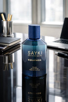 A sleek deep blue glass bottle of sayki equinox men’s eau de parfum 100 ml for men