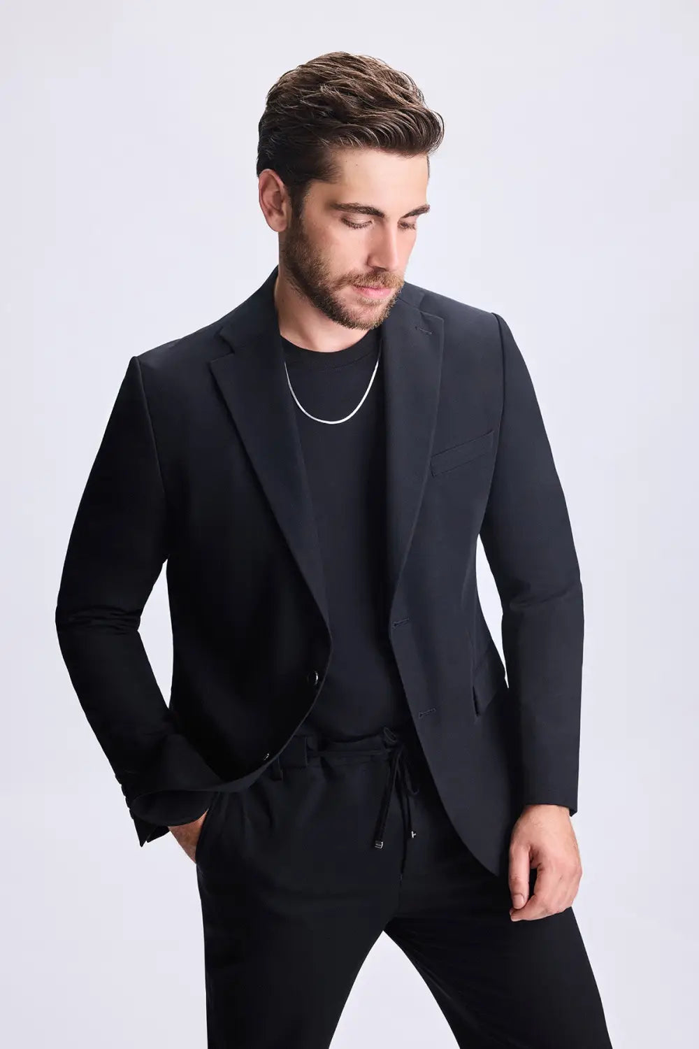 Model wearing brown textured blazer with olive green turtleneck and statement sunglasses