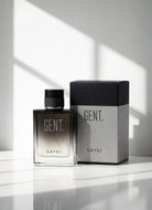 A sleek rectangular glass gent men’s eau perfume bottle with gradient dark to clear finish and black cap beside box