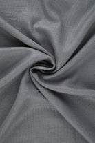 A soft, dark gray woven fabric with a subtle texture and gentle folds.