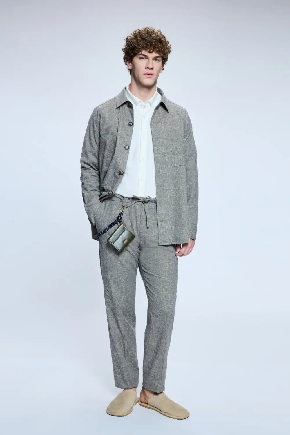 Model wearing grey textured suit