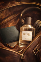 A clear glass bottle of sayki harvest men’s eau de parfum 100 ml with a dark wooden cap and minimalist white label