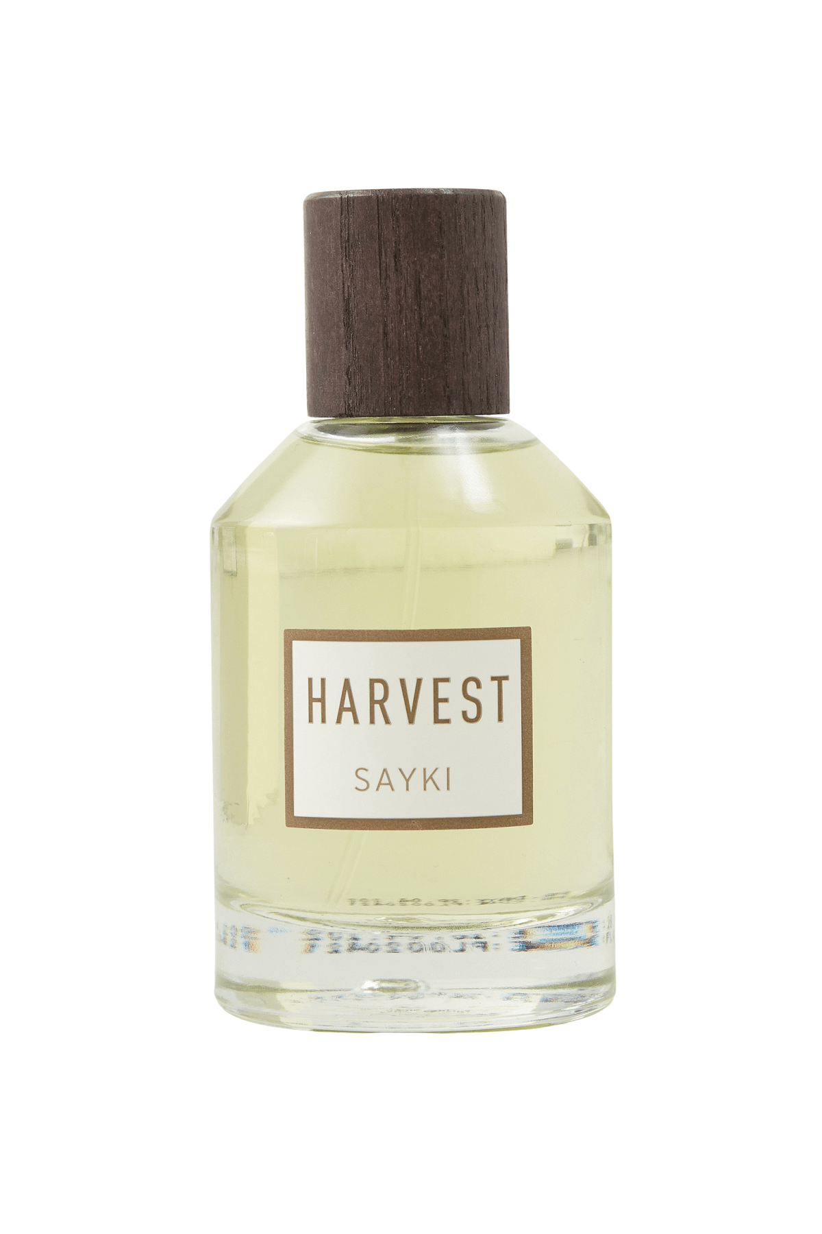 A clear glass bottle of Harvest mens eau de parfum 100 ml with pale yellow liquid and dark wood cap labeled harvest sayki