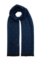 A navy blue scarf with a subtle pattern of teal polka dots, featuring black frayed edges and a small brand tag.