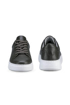 Black leather sneakers with a white rubber sole and matching laces.