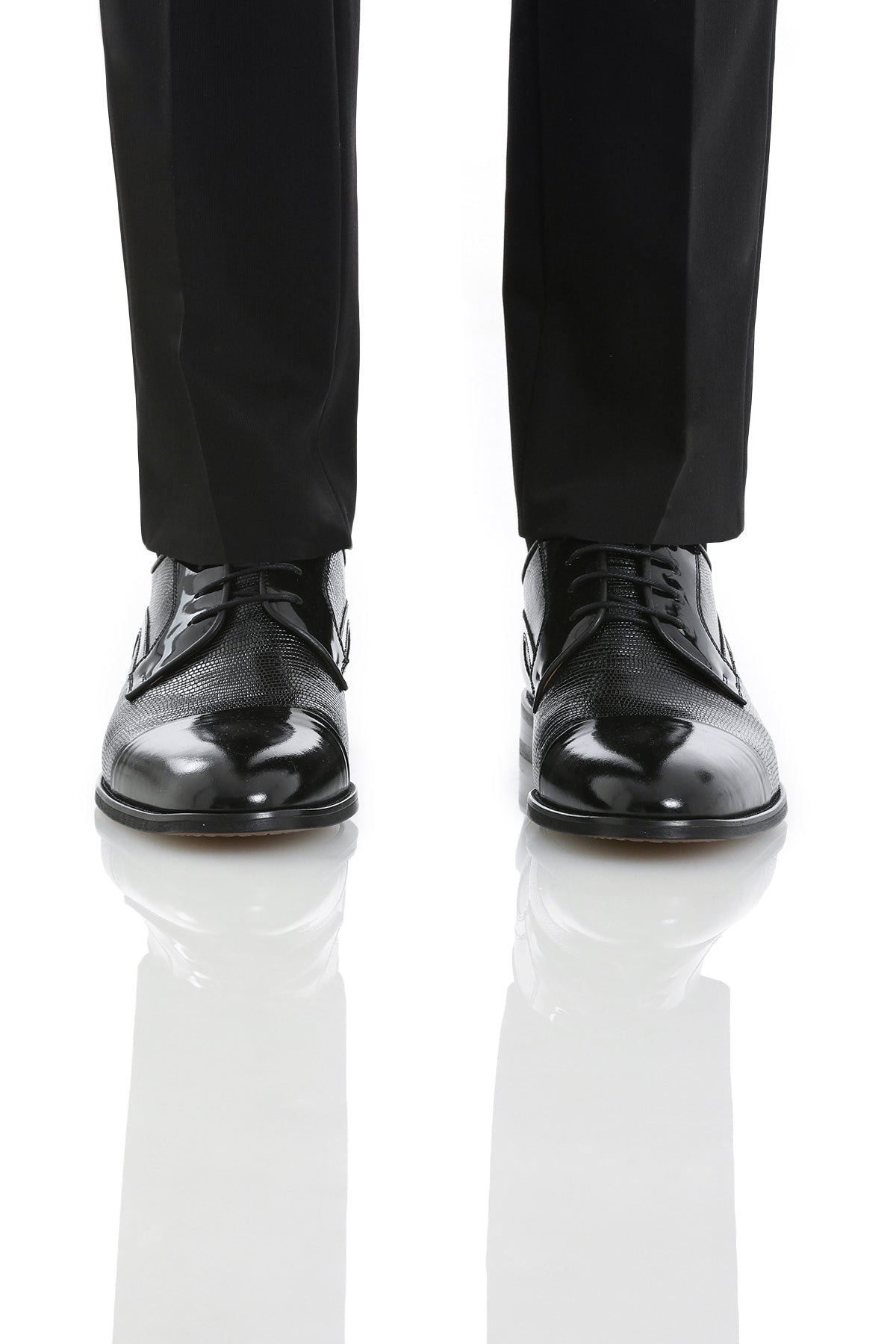 Black patent leather dress shoes with a glossy finish and subtle textured detailing on the upper.