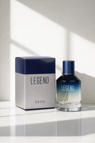 A sleek gradient blue-to-clear glass bottle of sayki legend men’s eau de parfum 100 ml with navy cap and box
