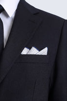 A crisp white pocket square with navy polka dot and light navy polka border folded in a black suit breast pocket