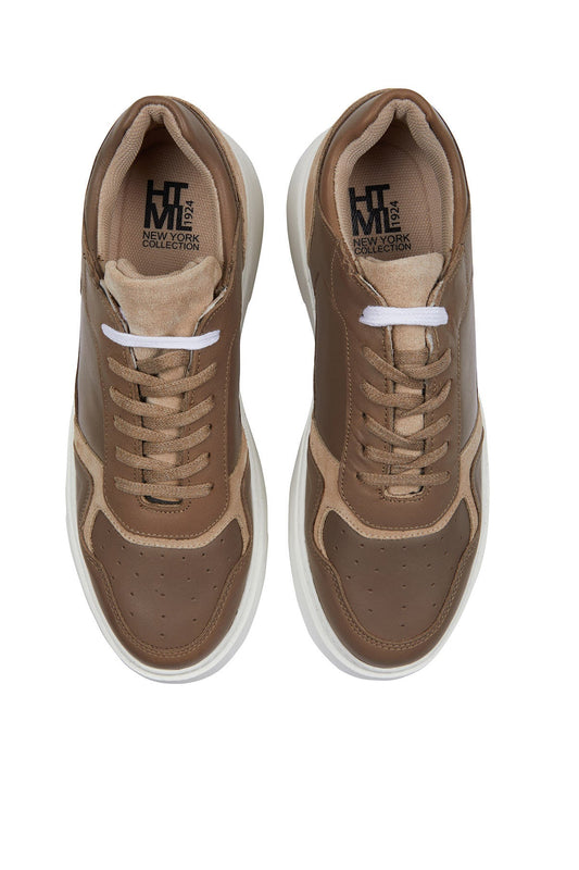 Brown and beige suede-and-leather sneakers with white laces and a chunky white sole.