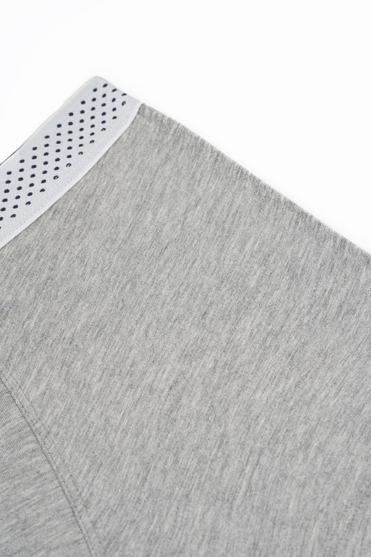 Gray heathered fabric with a white perforated trim along the edge.