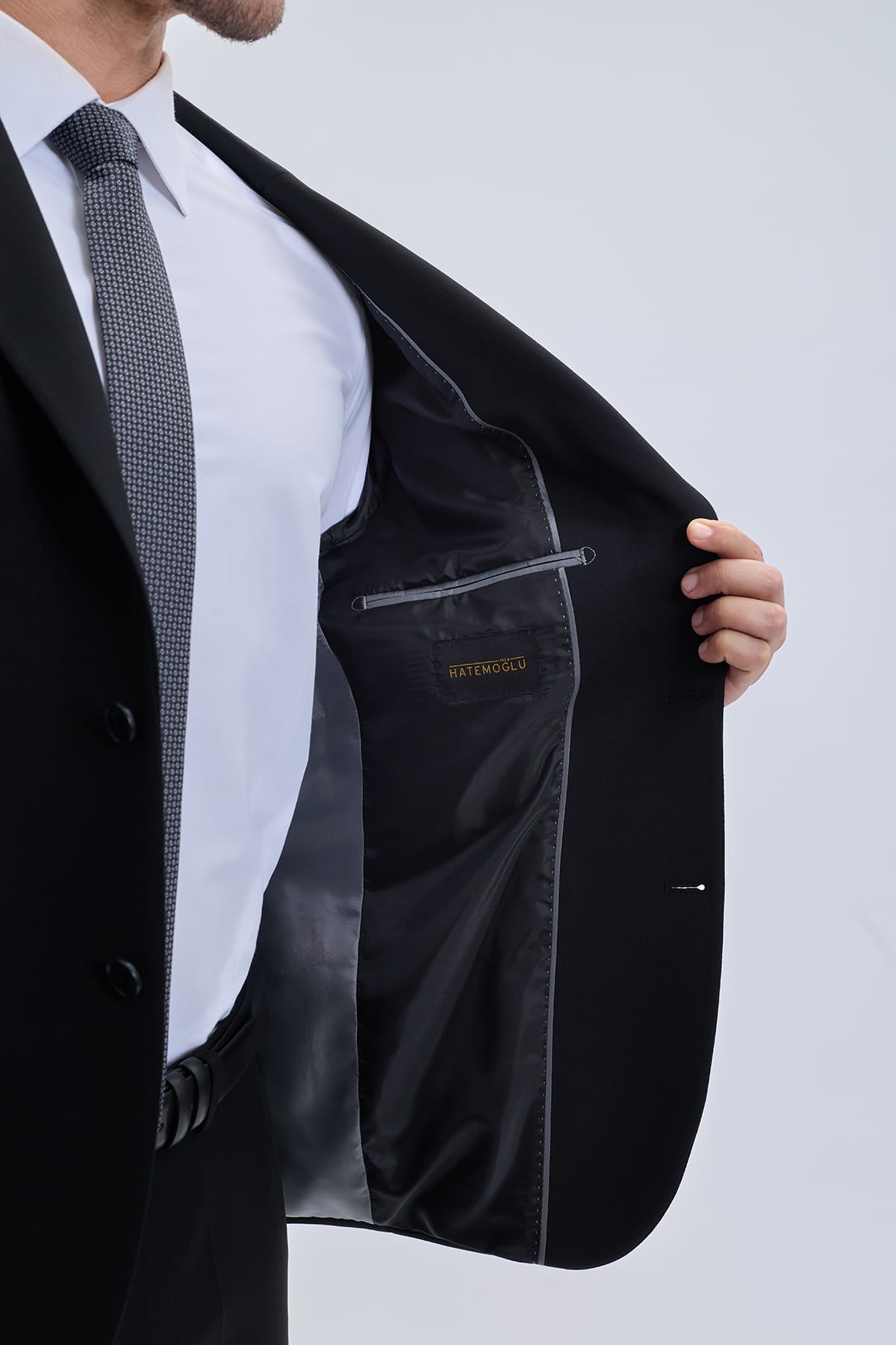 Muscle fit notch lapel black classic suit featuring a tailored jacket with sleek design and gray inner stitching