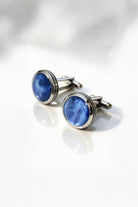 Navy natural stone round cufflinks featuring blue cat’s eye stone set in polished silver toned metal frame