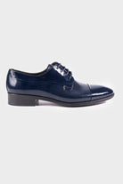 Navy blue patent leather dress shoe with a textured pattern and cap toe design.
