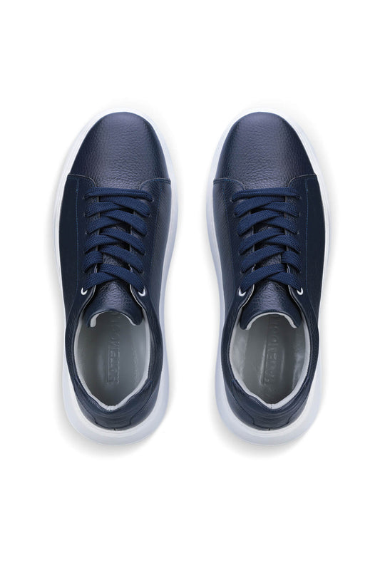 Navy blue leather sneakers with white soles and matching laces