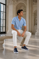 Navy pebble leather lace up sneakers in navy blue canvas with white rubber soles for casual wear