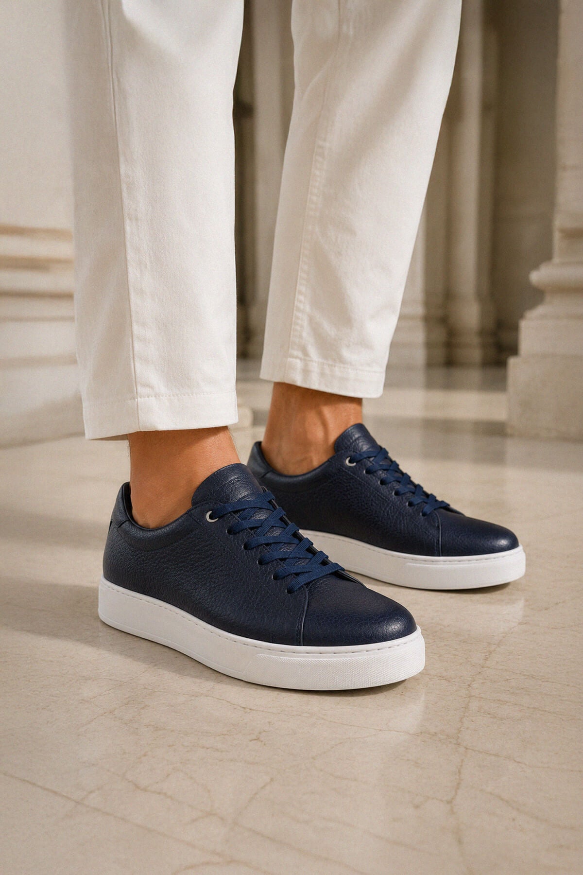 Navy pebbled leather lace up sneakers with white rubber soles in navy pebbled textured leather material