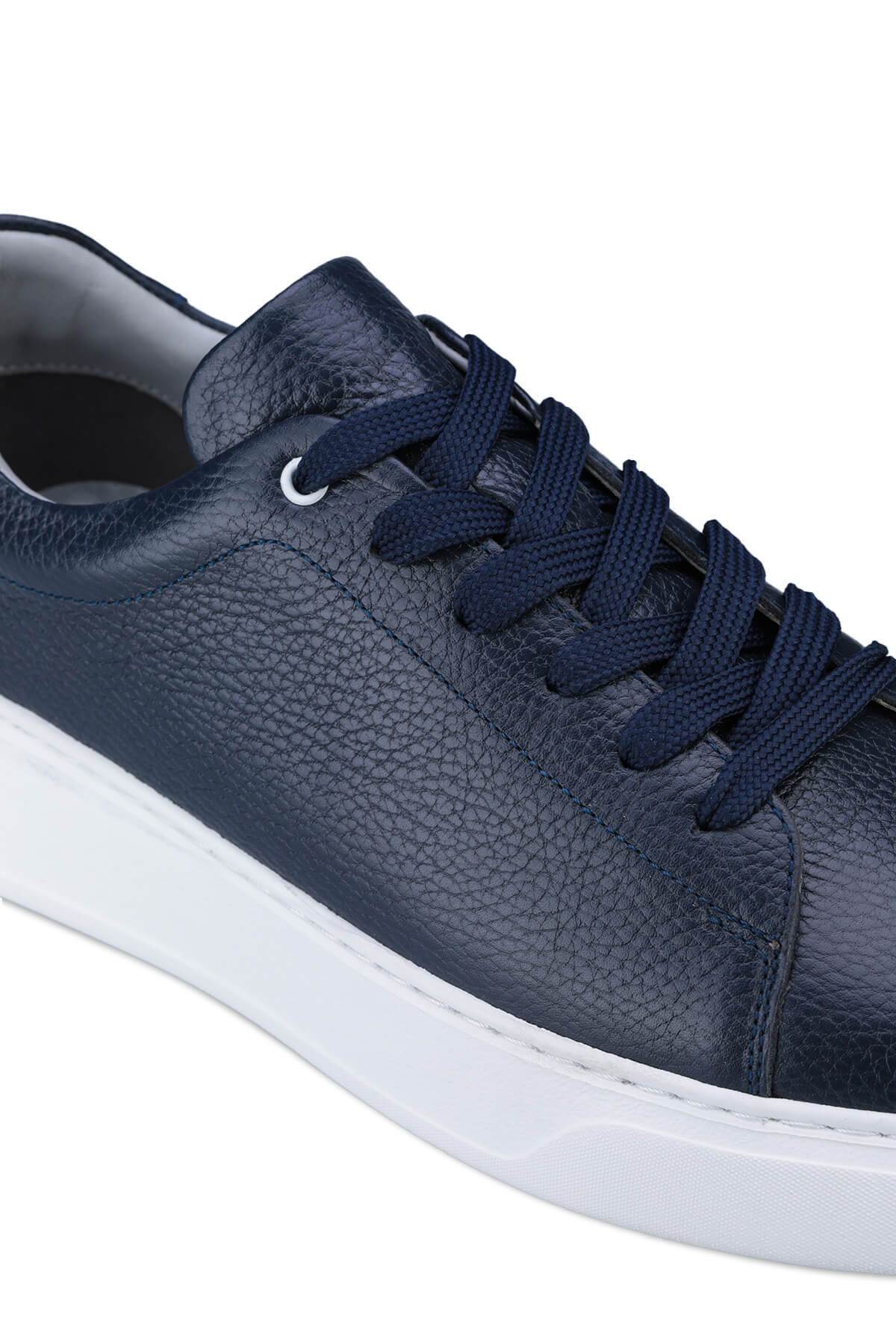 Navy blue textured leather low-top sneaker with white rubber sole and matching laces