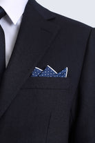 Navy polka dot pocket square with white polka dots and crisp white border folded in black suit jacket pocket