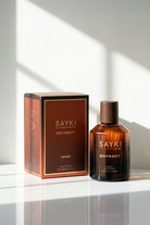 Sayki odyssey men’s eau in a sleek amber glass bottle with dark wood cap and matching brown box 100 ml
