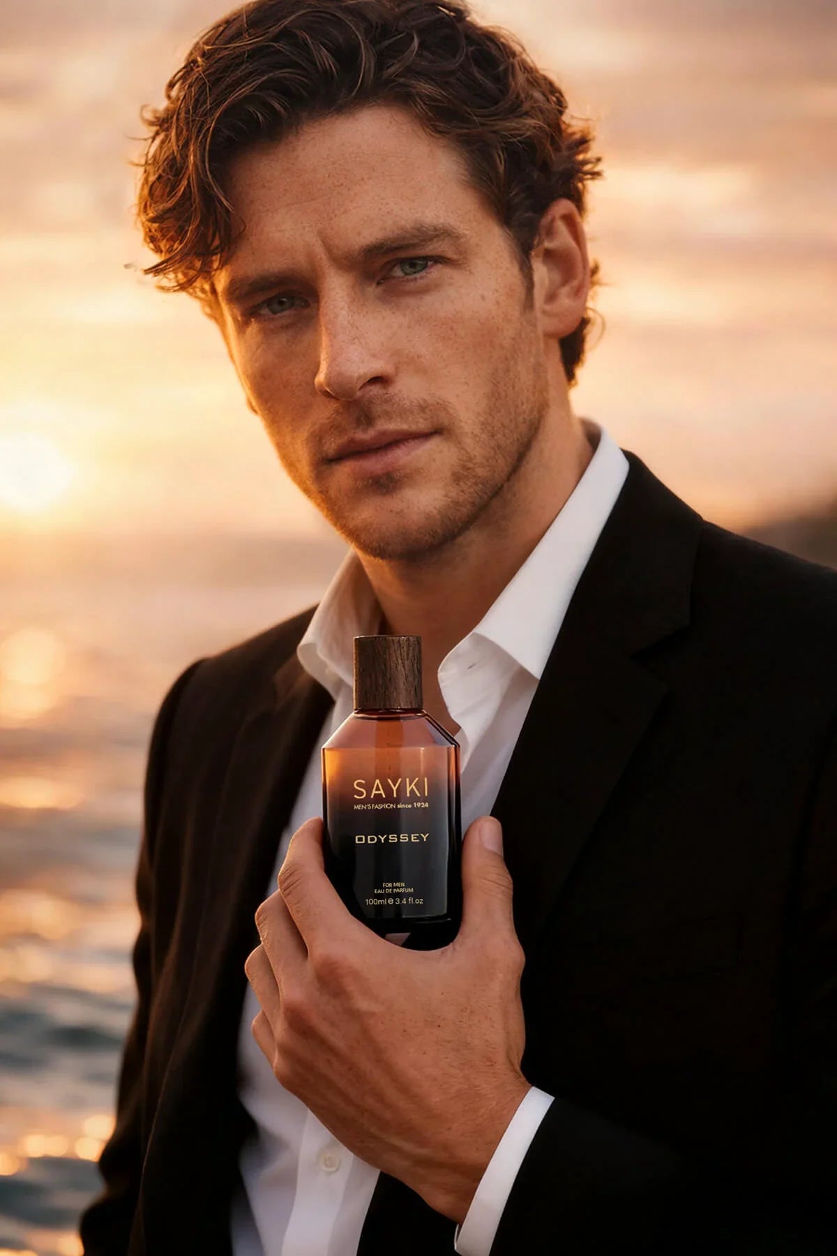 A sleek amber glass bottle of Odyssey men’s eau de parfum 100 ml with a dark wooden cap and minimalist black label