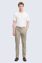 Beige cotton chino trousers with drawstring waistband complement olive dynamic fit jogger pants style