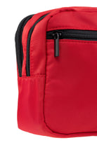 Red nylon crossbody bag with black zippers and zipper pulls.
