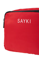 Red sayki brand travel bag with black zipper and white lettering.