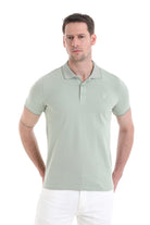 A men’s light green polo shirt with a subtle logo on the chest.